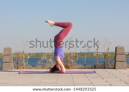 Yoga exercise - woman doing yoga pose meditation in the public park sport healthy concept. Portrait