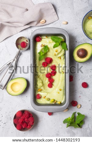 Homemade organic avocado ice cream in a bowl on gray background