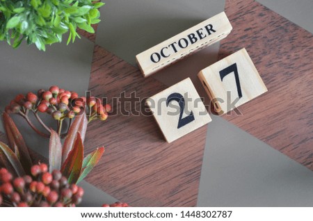October 27. Date of October month. Diamond wood table for background.