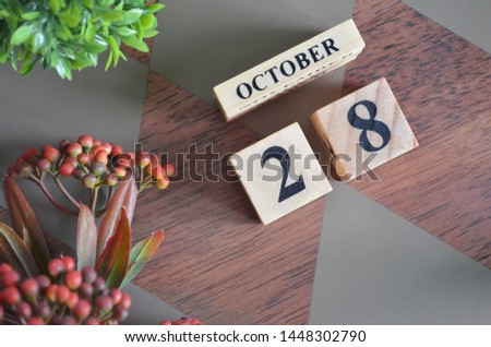 October 28. Date of October month. Diamond wood table for background.