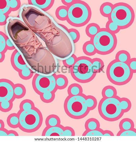 Pink women's sneakers cut on a pink background with blue bear print, youth trends, the right combination of colors, the concept of fashion and style, top view. Mock up, copy space.