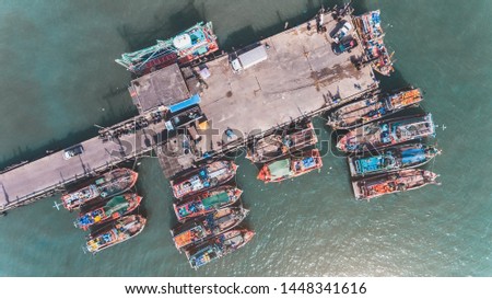 Top view from sky of group of wooden fishery boat at the sea marina with day lighting.