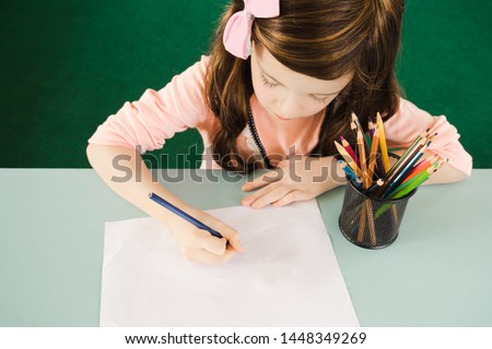 A little girl is drawing and painting pencil colors,artistic  education.Happy childhood.Copy space for text.Concept : Back to school and education.