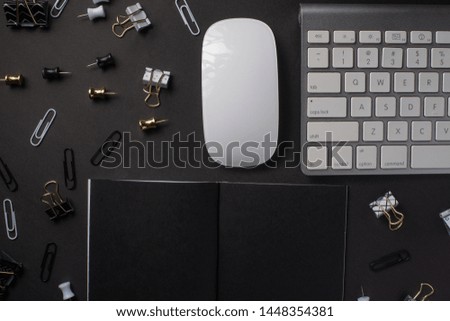 Layout with a black notebook blank for an inscription or design, with a pc keyboard, and a mouse. Business, work. Black style. Mockup