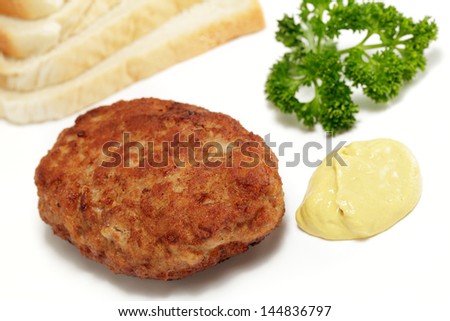 meatball with toast and mustard on a white background