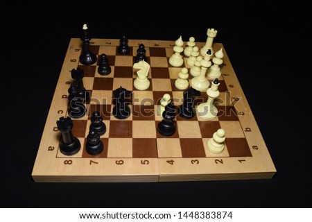 Wooden chess board with black pawns like a leisure theme