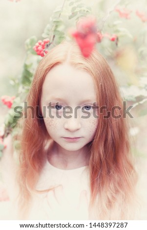 Teenage girl with red hair on the background of the forest