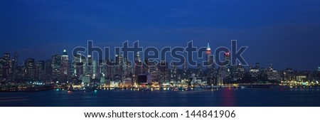 New York City skyline with Hudson River and harbor at night from Weehawken, NJ