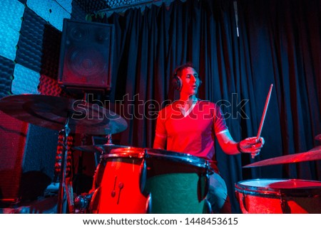 Man playing the drums at a rehearsal venue