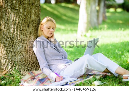 Natural environment office. Work outdoors benefits. Woman with laptop computer work outdoors lean on tree trunk. Girl work with laptop in park sit on grass. Education technology and internet concept.
