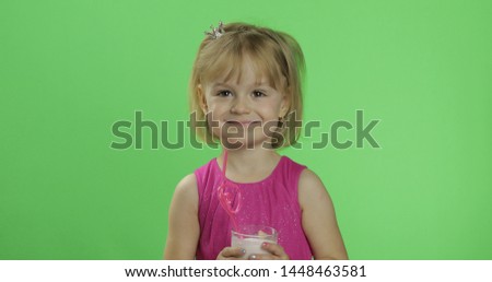Girl in pink dress with milkshake cocktail. Happy four years old girl. Pretty little child, 3-4 year old blonde girl. Make faces. Place for your logo or text. Green screen. Chroma Key
