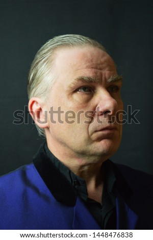 Grey haired man in blue suit