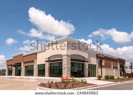 New Commercial, Retail and Office building Space available for sale or lease in mixed use Storefront and office building with awning Royalty-Free Stock Photo #144849883