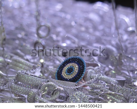 A beautiful blue ring standing out from the other silver rings.