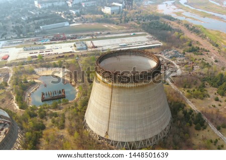 Drone flies over the cooling tower near Chernobyl nuclear power plant., zoom out, close up, top view. Flying over the cooling tower near the Chernobyl nuclear power plant. Territory near Chernobyl NPP Royalty-Free Stock Photo #1448501639