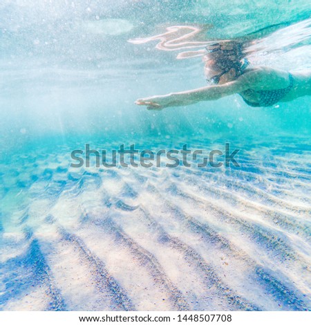 woman swimming in clear tropical waters - active holiday