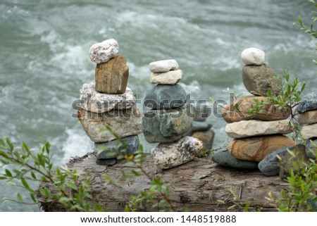 Balancing stones in equilibrium. Meditation and rest on the bank of the river.