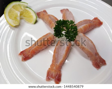 A delicious serving of butterfly cut scampi tails in white plate. Seafood edition.