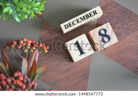 December 18. Date of December month. Diamond wood table for background.