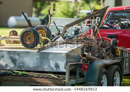 scrap metal and junk loaded on a trailer to be hauled away Royalty-Free Stock Photo #1448569853