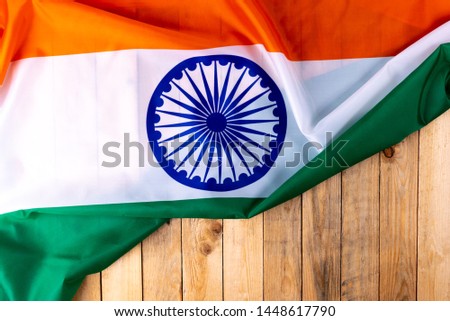 Top view of National Flag of India on wooden background. Indian Independence Day.
