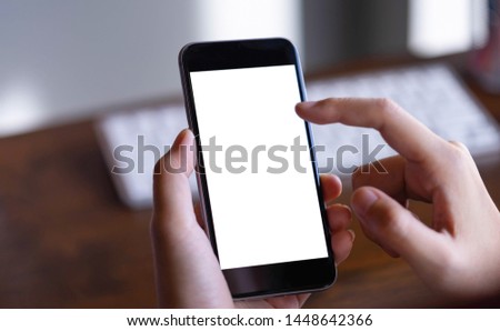 Woman holding smartphone with blank screen.Take your screen to put on advertising. Royalty-Free Stock Photo #1448642366