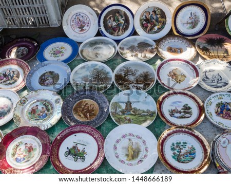 porcelain plates with beautiful pictures at the flea market