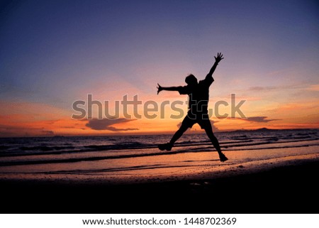 Happy man on the sunset in nature in summer with open hands.