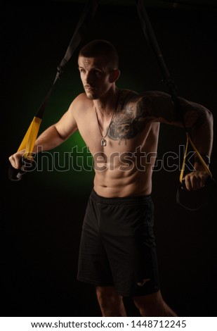 guy posing and practicing on TRX