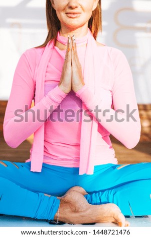 Young woman holding hands in namaste position
