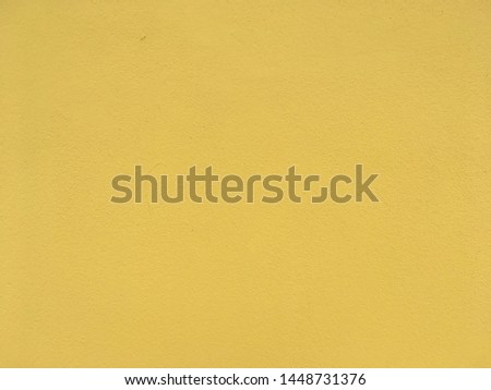 Yellow color concrete wall background and texture