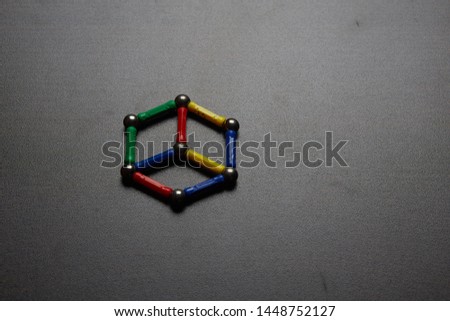 Children's multi-colored magnetic constructor in the form of physical shapes