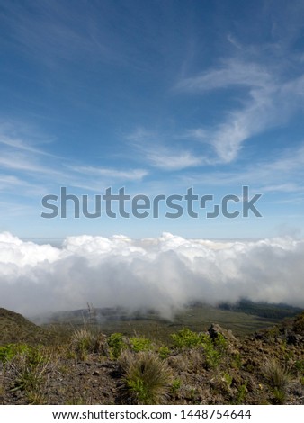 Standing on the higher ground above the clouds concept, Top of Haleakala volcano with beautiful mountain valley view on Maui Hawaii 