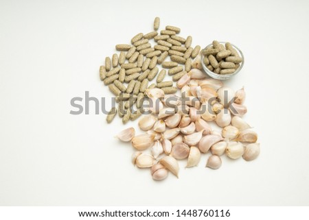 Supplements containing garlic. (Supplementary tablets place on a white background)