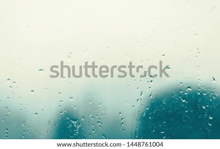 Bad weather, raindrops on the window, green background