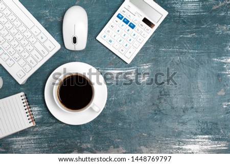 Office table with note paper, computer keyboard and supplies close up