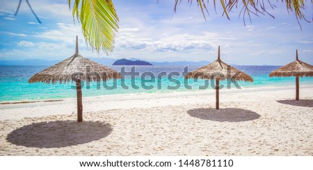 Beautiful tropical island with big umbrella and blue sky sunny day, summer and holiday in the nobody day, selection no focus, blurred picture