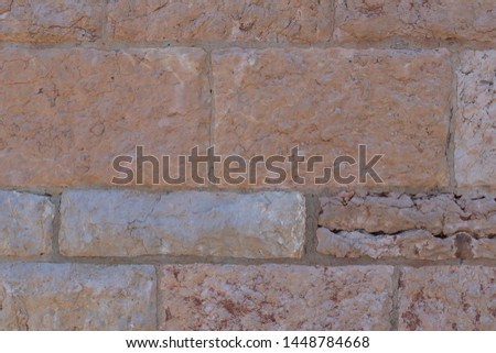 Texture of old ancient stone wall of a spanish church close up with cracks