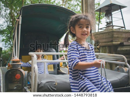 Daughters smile sitting in horse cart