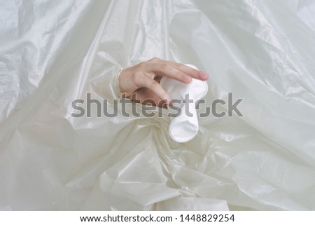 female hand with a plastic cup problems polyethylene prevention organic garbage recycling