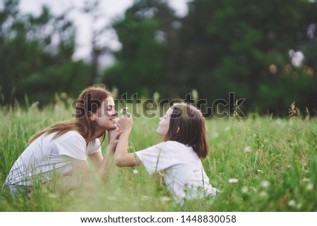 Mom and daughter walk across the field childhood fun nature joy lifestyle