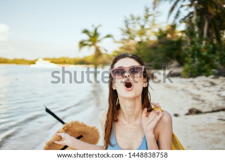 woman with a hat by the ocean                               