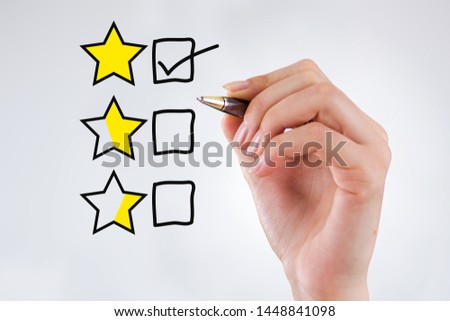 Customer Experience Concept, Hand with a pen with a checked box on Excellent Rating for a Satisfaction Survey