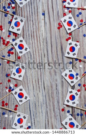 happy independence day South Korea. 15 Aug. the concept of freedom, independence and patriotism. mini flags with confetti on wooden background. vertical