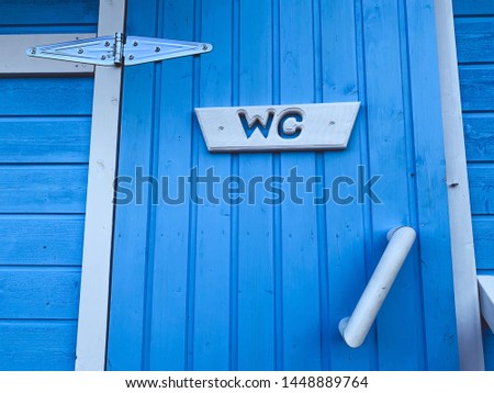 Wooden door of the WC cabin 