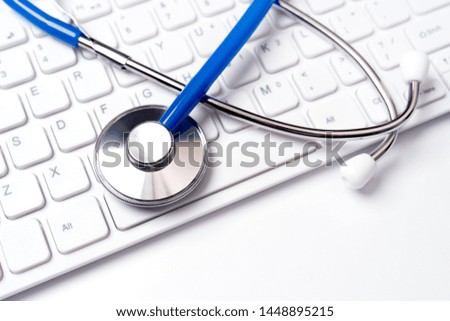 Medical Concept - Stethoscope on computer keyboard on white background. Physician long term care treatment. Close up, macro, copy space