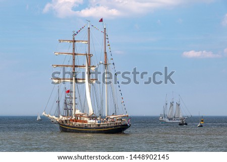 Antique tall ship, vessel leaving the harbor of The Hague, Scheveningen under a sunny and blue sky (similar RF pictures available for download, please check my portfolio)