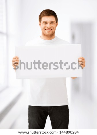 picture of young man holding white blank board