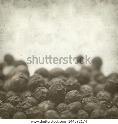 textured old paper background with black pepper