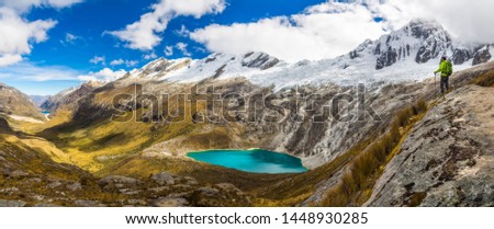 Panoramic High Quality Image (Over 60 Mega Pixels) Climber on Top of a Hill Looking at a Beautiful Valley with Snow peaks and a Blue Turquoise Lagoon During Santa Cruz Trekking, Ancash, Peru